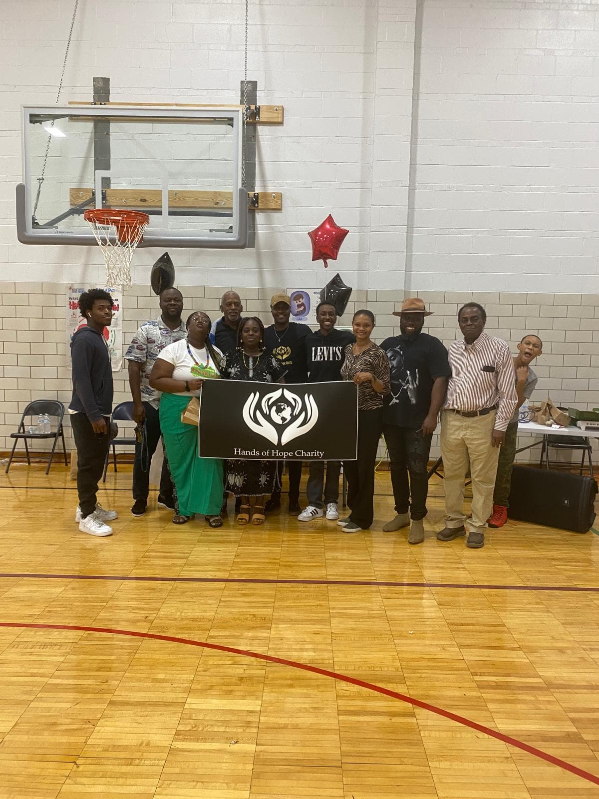 Members and volunteers of Hands of Hope Charity with the organization's banner at a community event in Springfield.